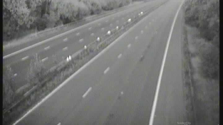 A blurry picture from a traffic camera which shows an empty motorway between junctions 12 and 13.