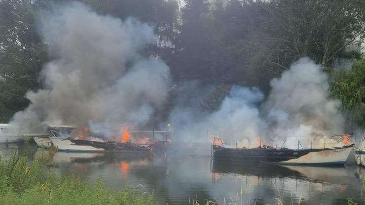 Boats destroyed by fire as flames start to die down