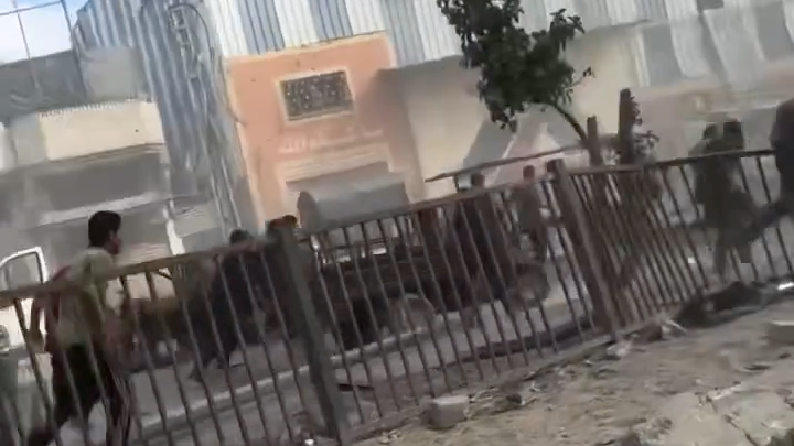 Screengrab of a video posted to Instagram showing Palestinians running near lifeless bodies