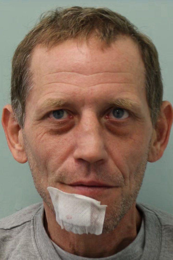A custody shot of Daniel Whybrow, he has a white dressing on his chin