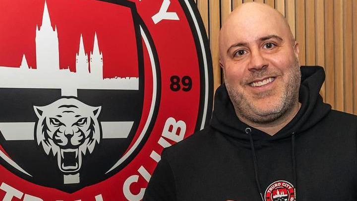 Eric Perez beside a Truro City sign