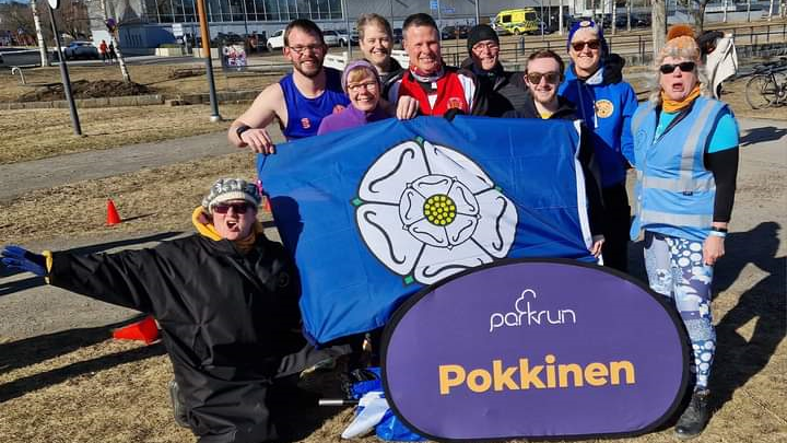 Runners pose with a Yorkshire flag during Pokkinen Parkrun