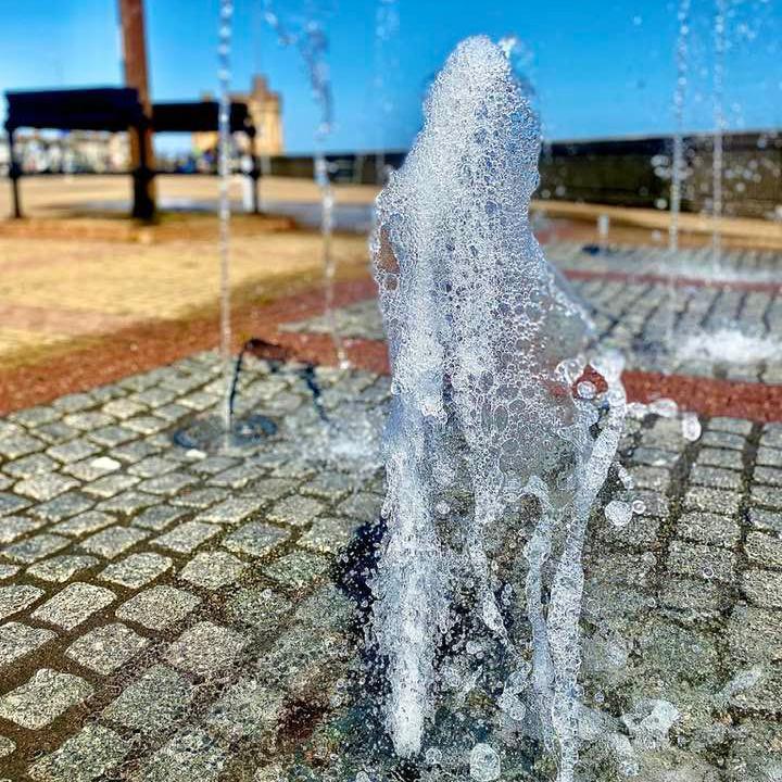 Water spouts from the seven fountains on a sunny day on a promenade