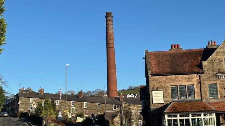 An image of a 42m-tall chimney stack in Milford Derbyshire