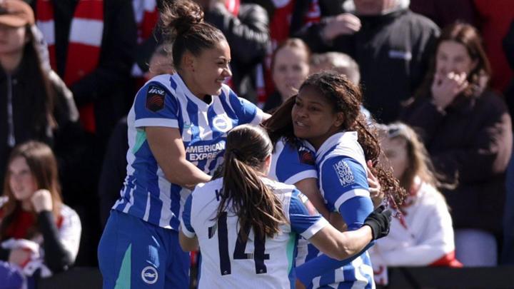 Brighton celebrate after defeating Arsenal at Meadow Park
