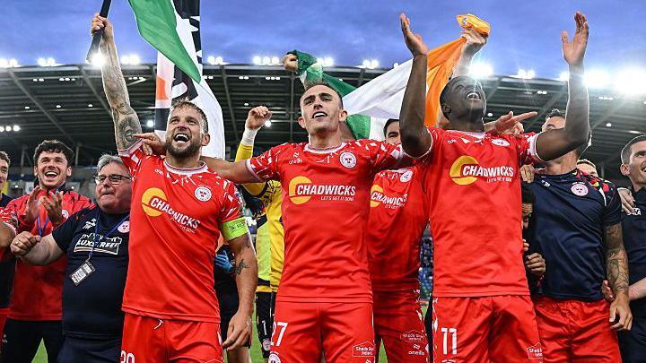 Shelbourne players celebrate at Windsor Park