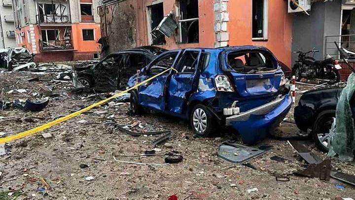 Bombed street and blast damaged car in Ternopil region of Ukraine, pictured in June 2022