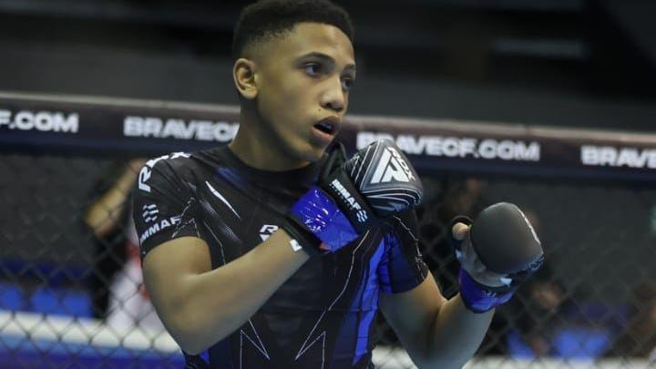 Cairo with his fists up ready to fight in an MMA boxing ring