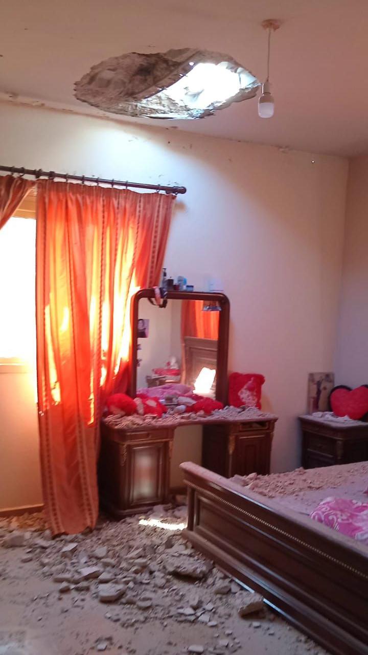 Rubble lies on bedroom furniture beneath a hole in a ceiling at Rasha Makhbour's home, in Rmeish, southern Lebanon