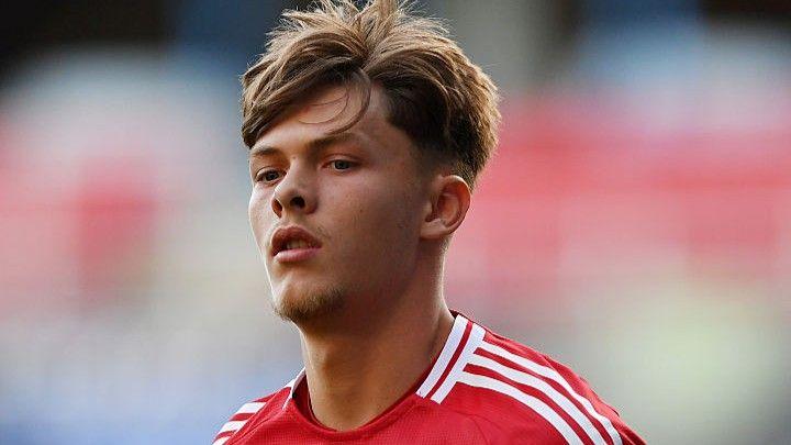 A picture of Sam Mather in a red Manchester United shirt