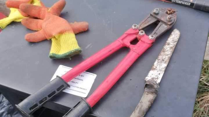 A pair of bolt cutters and some gloves 