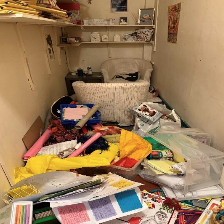 A messy store room strewn with combustibles - including bags of paper, fabric chairs and stationary.