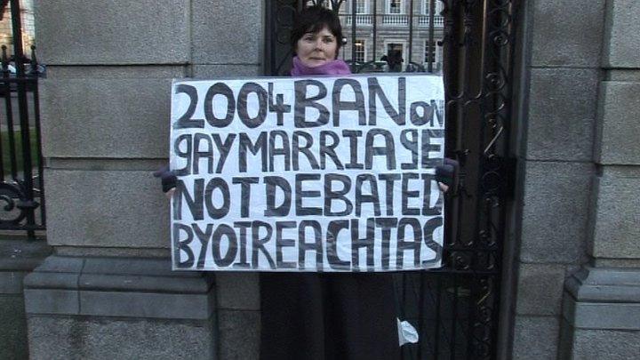 Jackie Mullins holds a placard outside the Irish houses of parliament