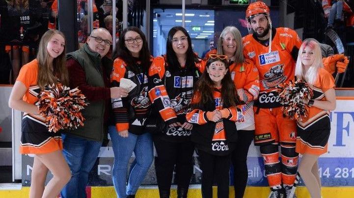 Steve Owen with members of his family and Sheffield Steelers cheerleaders