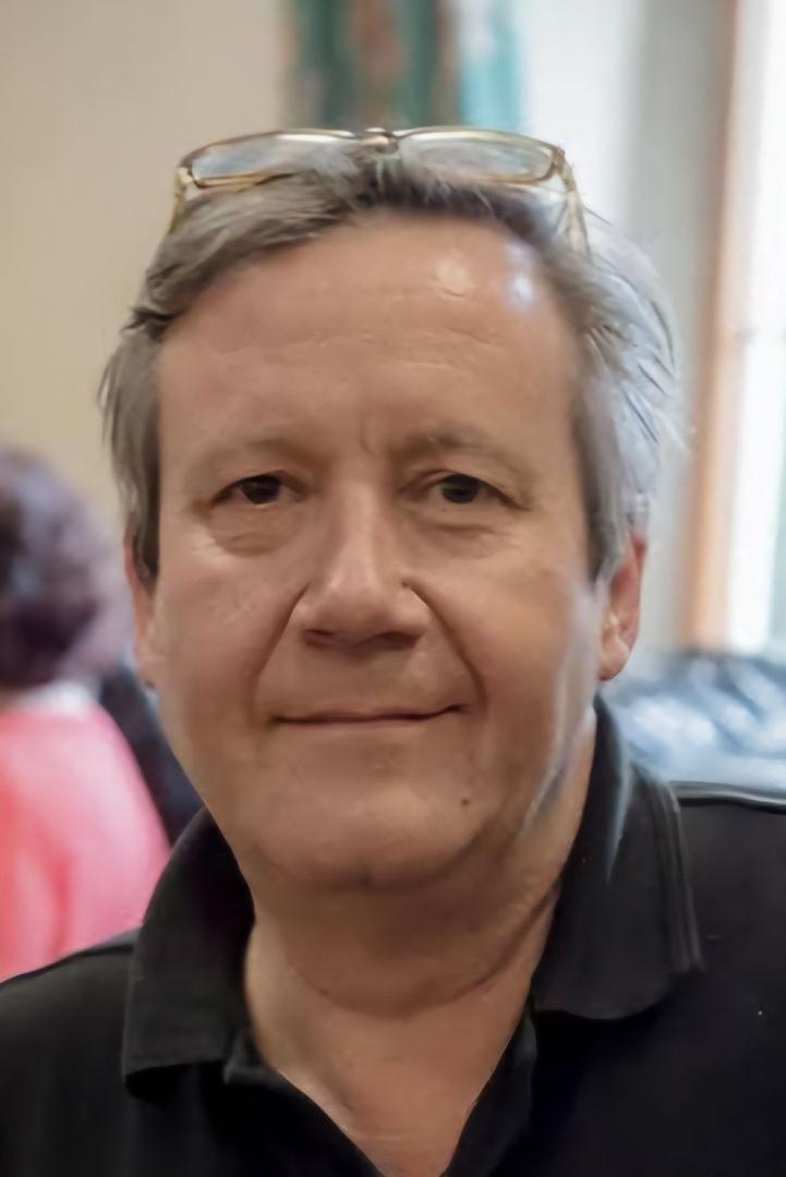 Steve Richardson, who has grey hair, dark eyes and is wearing a black polo shirt. He is smiling in the photo.