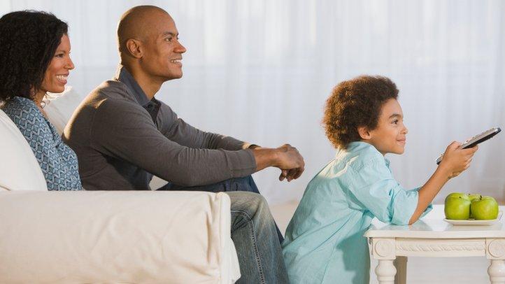 African family watching TV