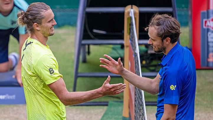 Daniil Medvedev shakes hands with Alexander Zverev at the net