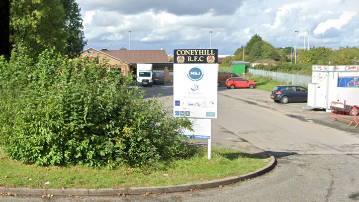 A Google Maps view of Coney Hill RFC. A rugby club sign outside of a car park where some cars are parked and a food truck.