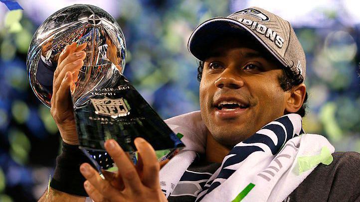 Russell Wilson holding the Lombardi Trophy after the Seattle Seahawks win the Super Bowl in 2014