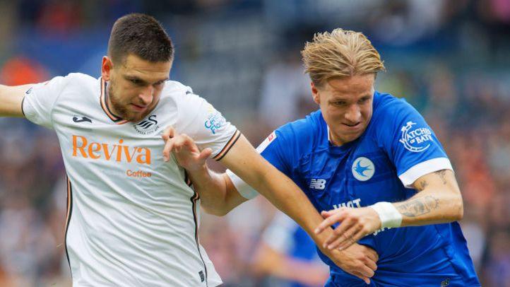 Swansea City striker Zan Vipotnik (L) battles with Cardiff City centre-back Jesper Daland