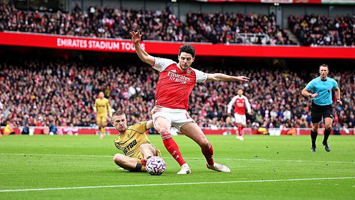 Declan Rice of Arsenal and Adam Wharton of Crystal Palace battle for possession.
