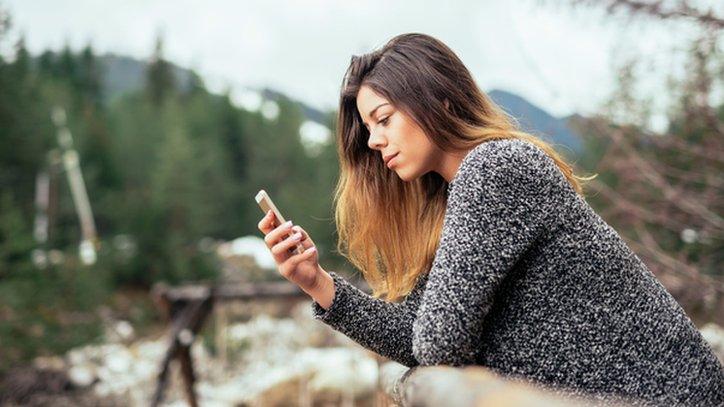 Woman on phone in rural setting