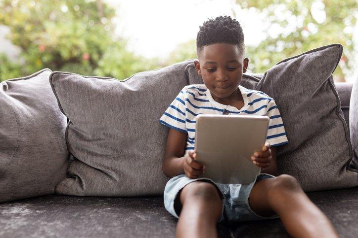 boy reading iPad or tablet