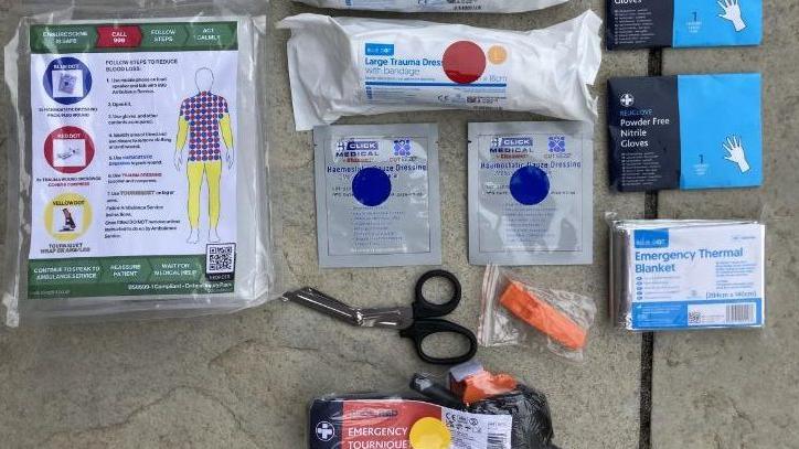 A bleed kit from HeartSafe which includes a tourniquet, thermal blanket, scissors, dressings and gloves