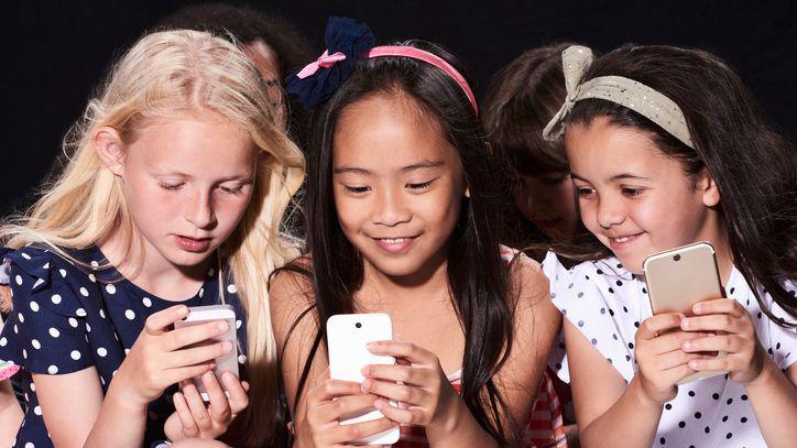 A group of friends using their phones.