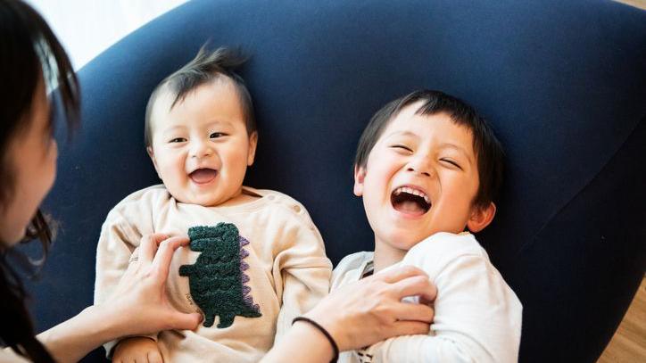 Two young children being tickled.