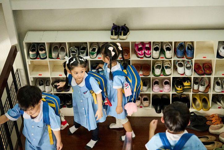 children with shoes in cubbies