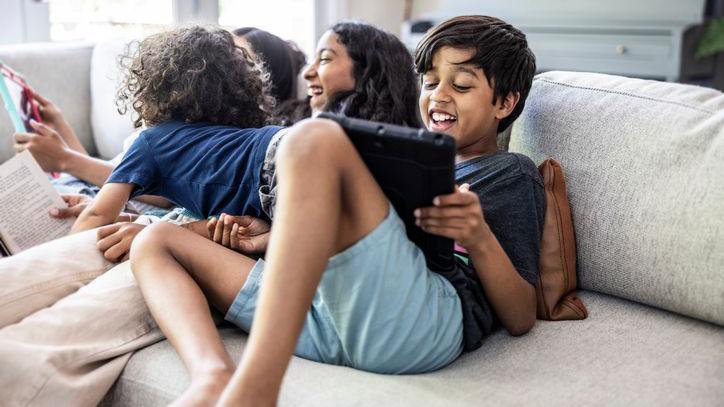 children having fun playing on devices