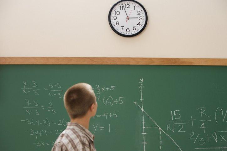 boy watches clock