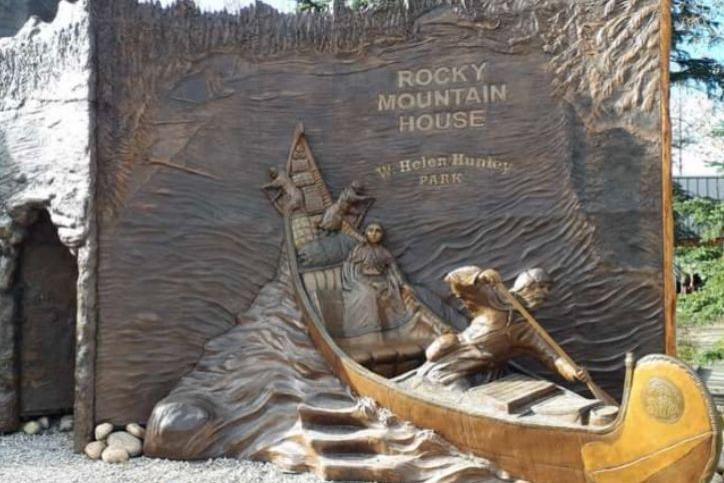 A sculpture of a canoe protruding from the rockface at "David Thompson Country". It depicts David, Charlotte and some of their many children rowing through the rapids.