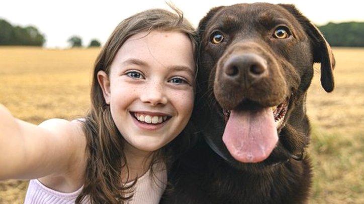 Girl and pet labrador