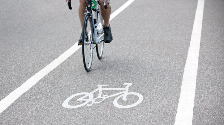 Man riding a bike in a cycle lane