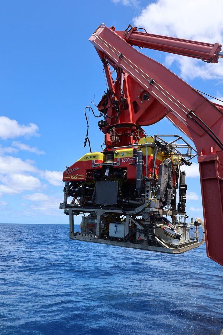 A remotely operated deep ocean lander being deployed from the back of a research vessel 