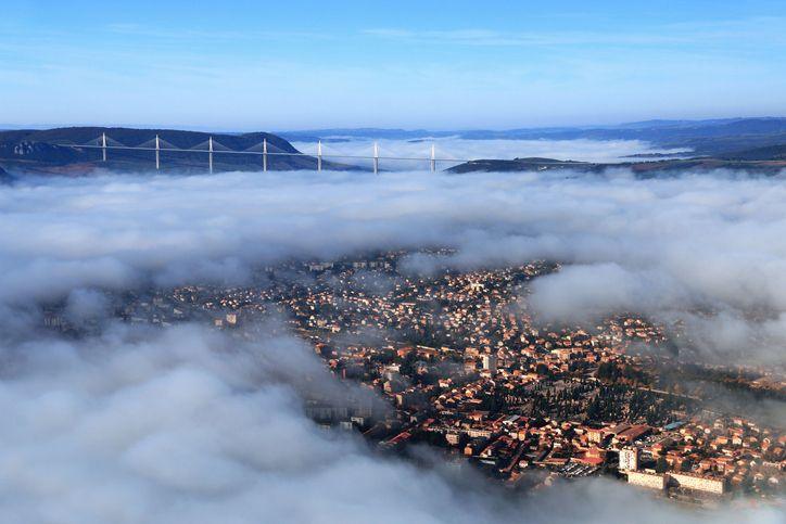 Aerial view of the city of Millau in France with the bridge in the distance.