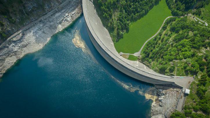 Aerial view of bridge on large dam in Swiss Alps