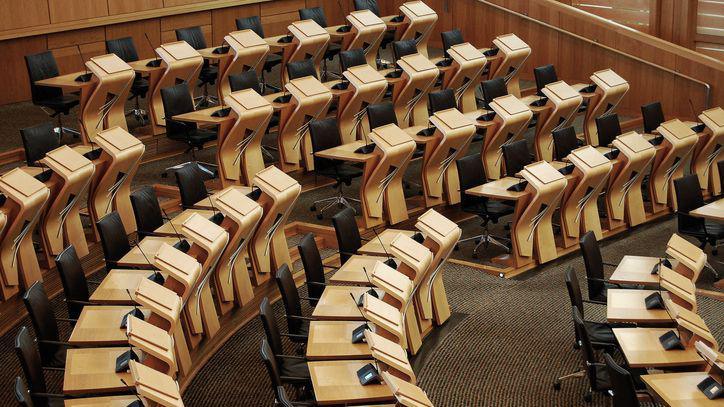 Horizontal shot of the desks inside of the Scottish parliament building.