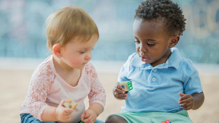 Two babies playing together.