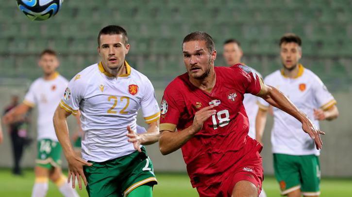 Bulgaria's Marin Petkov chasing the ball alongside Serbia's Djordje Jovanovic