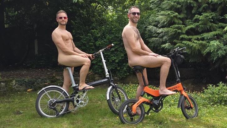 Shayne and Stephen post on their bikes naked.