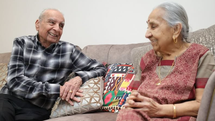 An older couple sitting on a sofa