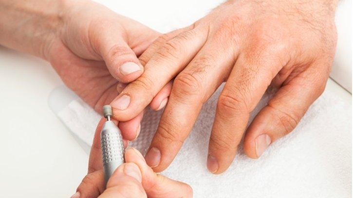 Man's hands being manicured