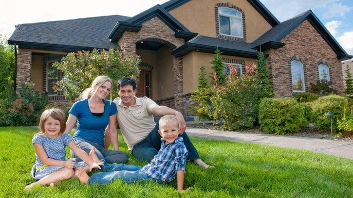 Family in front of house