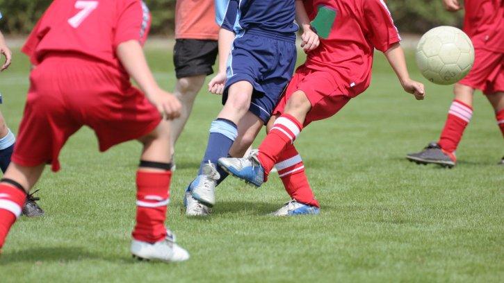 Children playing football generic