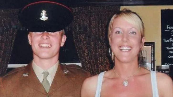 Pte Stone, wearing a ceremonial, dark green Army dress uniform and cap, with his sister Jennie, who is blonde haired and wearing a white vest top.