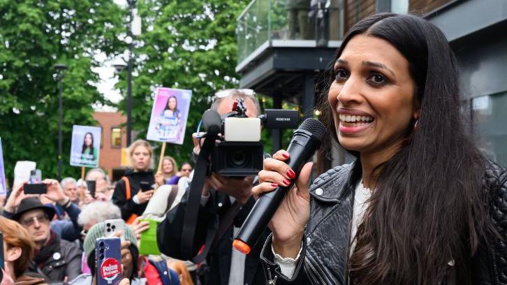 Faiza Shaheen speaks to supporters during a rally