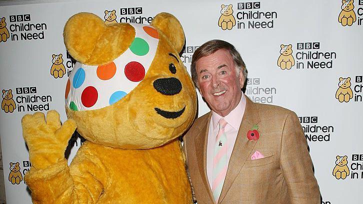 Sir Terry Wogan posing with Pudsey 